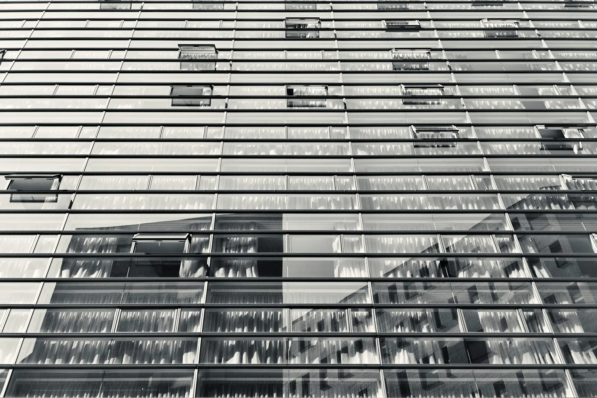 Reflections of one apartment building in the windows of another across the street